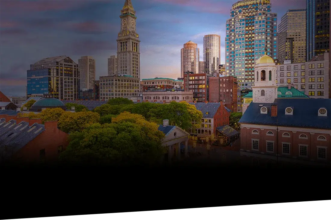 Boston, Massachusetts skyline at dusk seen from across the harbor